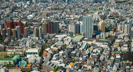 Aerial view of Tokyo City, tall buildings and homes and the city's growth..