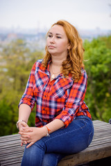Obraz premium Simple american girl from next door in a plaid shirt walk in central park. Smiling and laughing have fun time