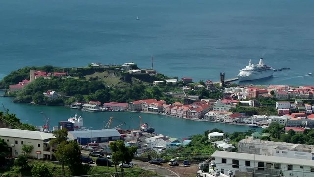 Wide elevated static shot of St George&rsquo;s town, harbour and cruise ship docked nearby, Grenada. Taken from the hill