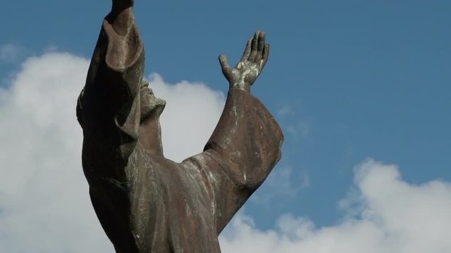 Close shot of statue Christ of the Abyss and white clouds rolling behind in St George’s town, Grenada