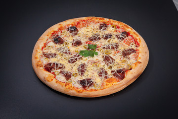 Pizza with dried tomatoes on a chalkboard