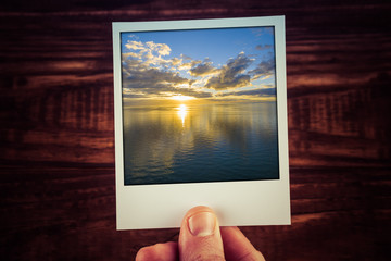 Polaroid postcard of golden sunset over water. Nothing but skies, sun and water. Perfect for scrapbooking with copy space