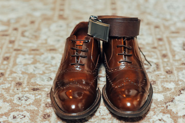 A new pair of tan leather shoes, belt