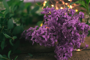 Blossoming lilac on a wooden background.