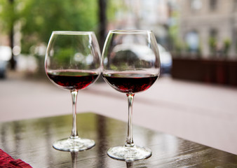 Two glasses with red wine in a cafe