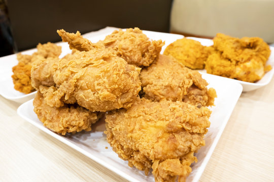 crispy kentucky fried chicken on a white plate and table.