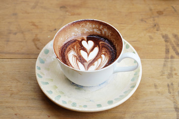 Hot Chocolate - A cup of dark chocolate with beautiful latte art on wooden background, Morning breakfast.