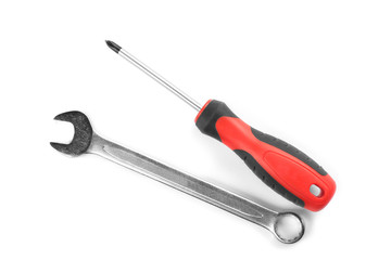 Combination wrench and screwdriver on white background