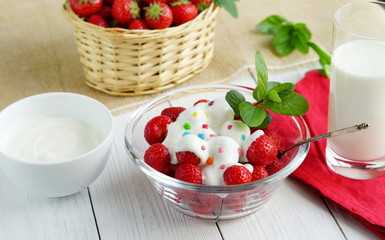 Tasty dessert for health strawberry with yogurt and a glass of milk on a white wooden background