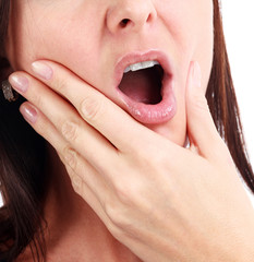 Closeup of woman in strong toothache pain with hands over face. Dental health and care concept....