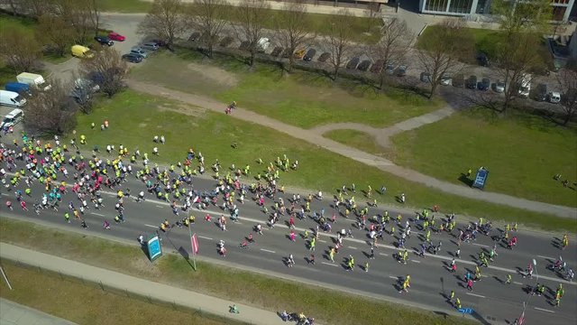 Aerial View of Traditional Lattelecom Marathon May 2017 in Riga City, Latvia, People running through the Streets of Riga Down the Krastmala Street, View from Above