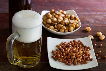 Beer in glass and snack eat with alcohol on the old wooden table