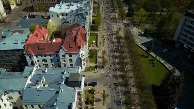 Aerial Shot of Marathon Runners run at the Riga International Marathon on May 14, 2017 in Riga, Latvia, View from Above, Top View of Riga Old City, Park and Buildings