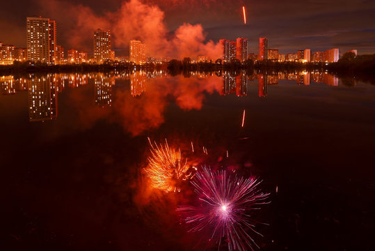 Fireworks in the park. Reflection in the water. Moscow.