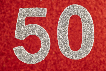Number fifty silver color over a red background. Anniversary.