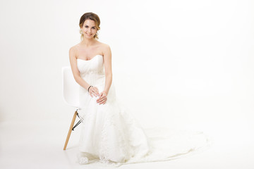 Fototapeta na wymiar beautiful happy bride in wedding dress on white background