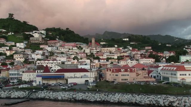 View of white dramatic clouds behind St George’s town in Grenada taken at dusk
