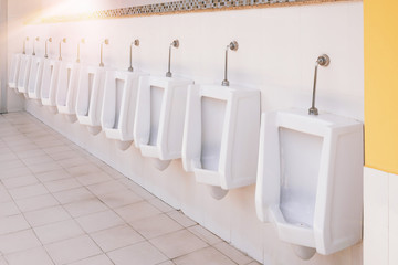 Public toilet / Empty urinals in public toilet for men only.