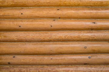 Wooden wall of a log house. Log Cabin Or Barn Unpainted Debarked Wall Textured Horizontal Background With Copy Space