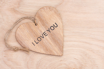 Wooden heart with the words love on wooden surface