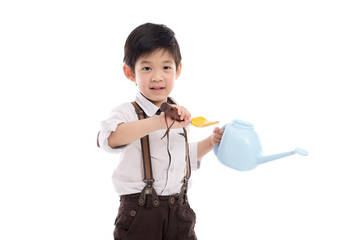Asian child holding gardening tools