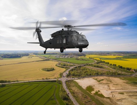 
Black Hawk military Helicopter in flight - aerial view close up