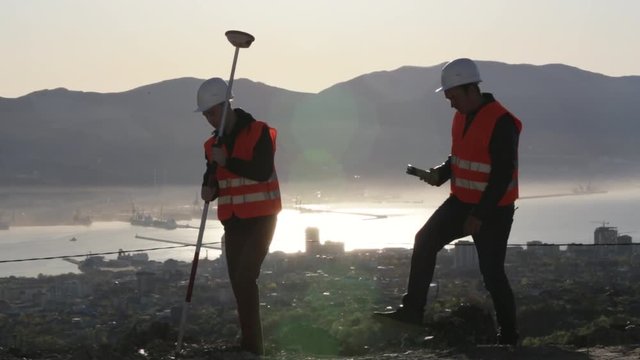 Two surveyors working on the ground since early morning