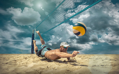 Obraz premium Beach volleyball player in action at sunny day under blue sky.