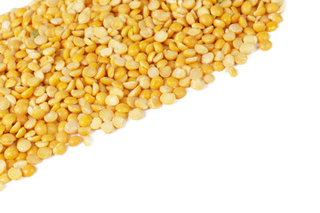 Dry yellow split peas isolated on white.