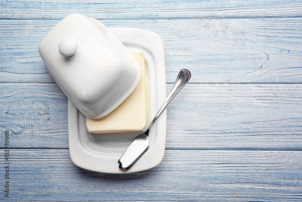 Sticker Dish with butter and shovel on wooden table