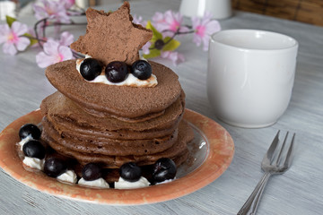 Stack of chocolate pancakes with blueberries toppings