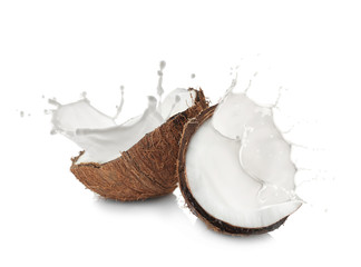 Coconut halves on white background © Africa Studio