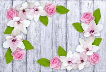 Magnolia with roses on background of shabby wooden planks