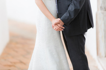 Bride and groom holding hands