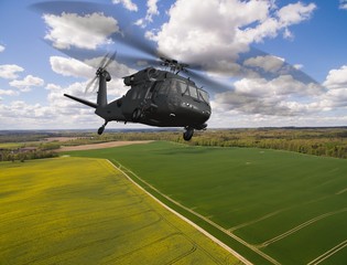 Fototapeta na wymiar Black Hawk military Helicopter in flight - aerial view close up