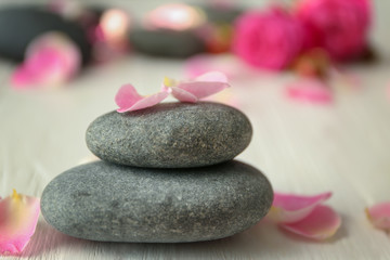 Fototapeta na wymiar Spa stones and petals, closeup