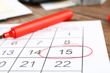 Marked calendar on table. Tax concept