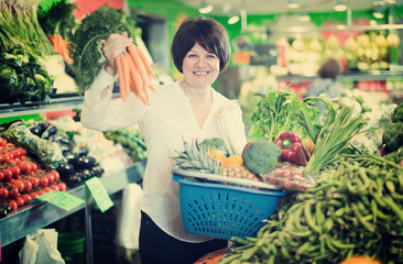 Adult female taking vegetables with basket