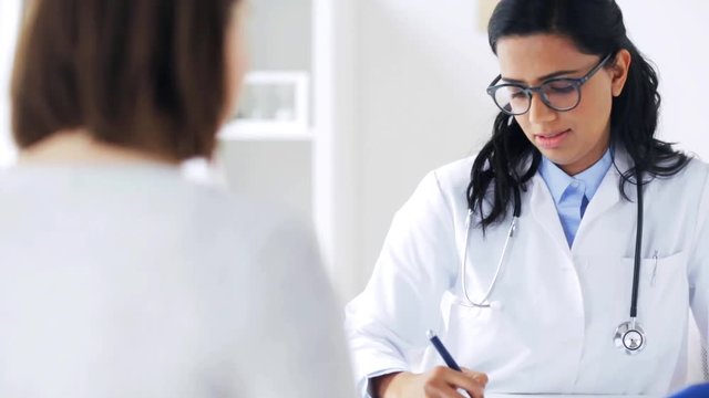 doctor talking to woman patient at hospital