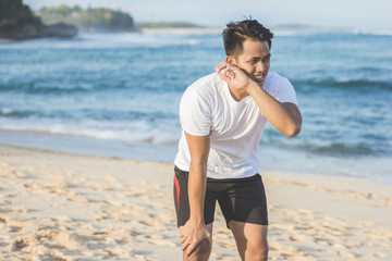 sport man taking a break during jogging