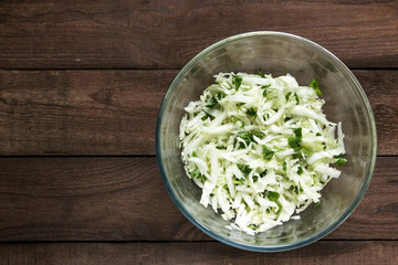 Salad With Green Cabbage And Parsley on a Wooden Background