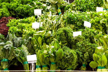 various of fresh green vegetables at grocery store