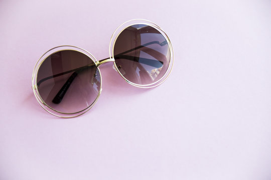 Sunglasses for summer on a bright pink background