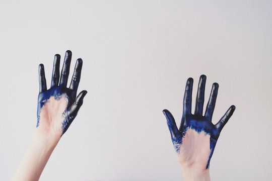 Painted blue hands are give up