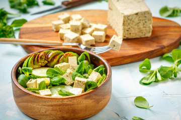 Green vegan salad with tofu, avocado and cucumber. Love for a healthy vegan food concept