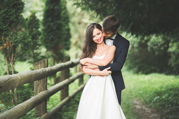 Beautiful, perfect happy bride and groom posing on their wedding day. Close up portrait