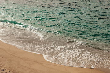 Foamed waves breaking in the beach