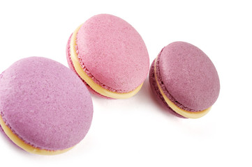 Colorful French almond cookies macarons or macaroons isolated on white background. Top view.