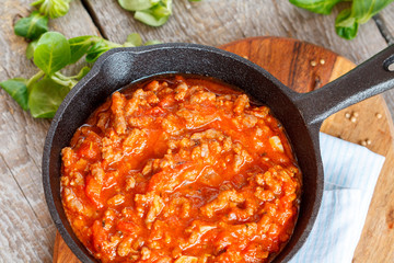 Pasta Bolognese in a cast-iron frying pan.