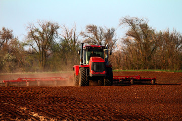 Fototapeta premium Soil preparation with a tractor